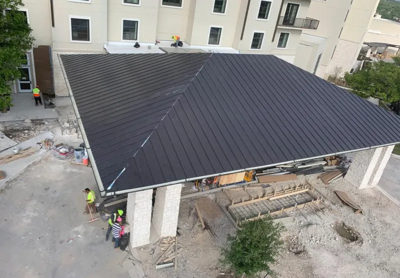 Metal roofing installation team working on a commercial building in Richfield